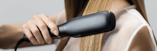 close up image of a woman straightening her hair with a Neuro Smooth+ 1.75" Ceramic Straightening & Styling Iron
