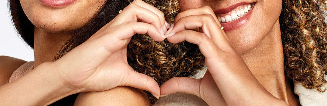 image of two women joining their hands to create a heart