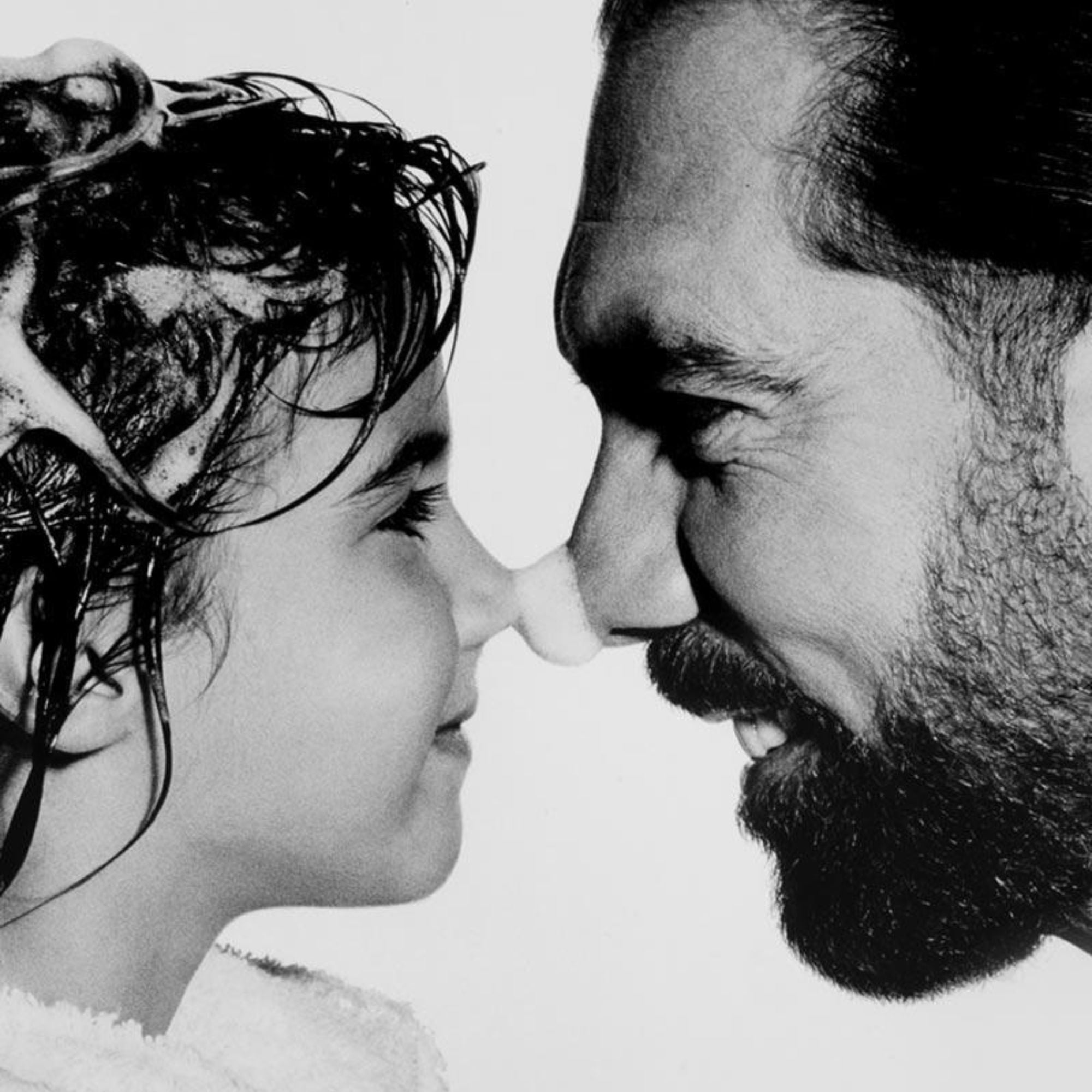 Black and white image of John Paul and Michaeline DeJoria sharing a sentimental moment