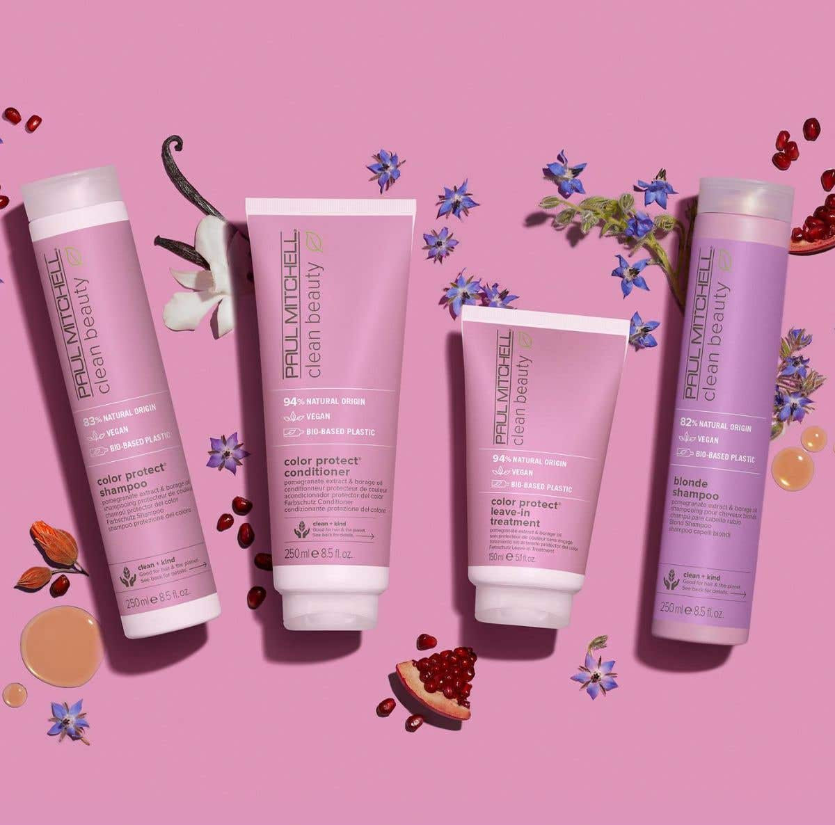 Clean Beauty Color Protect Collection artistic image with ingredients surrounding the bottles on a light pink background