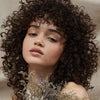 Tea Tree female model with curly haired finish look in lifestyle setting