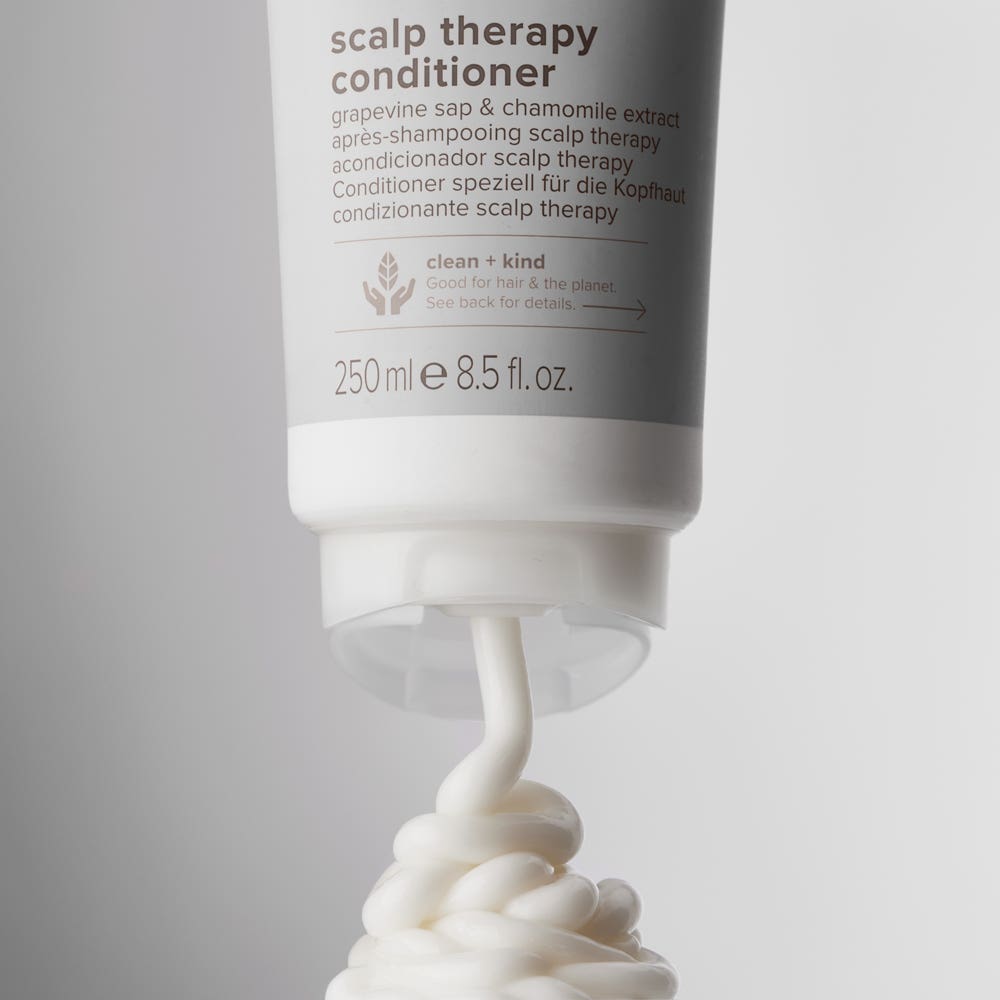 Close-up image of Clean Beauty Scalp Therapy Conditioner being dispensed from the tube