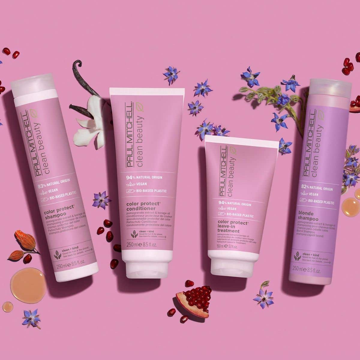Clean Beauty Color Protect Collection artictic image with ingredients surrounding the bottles on a light pink background