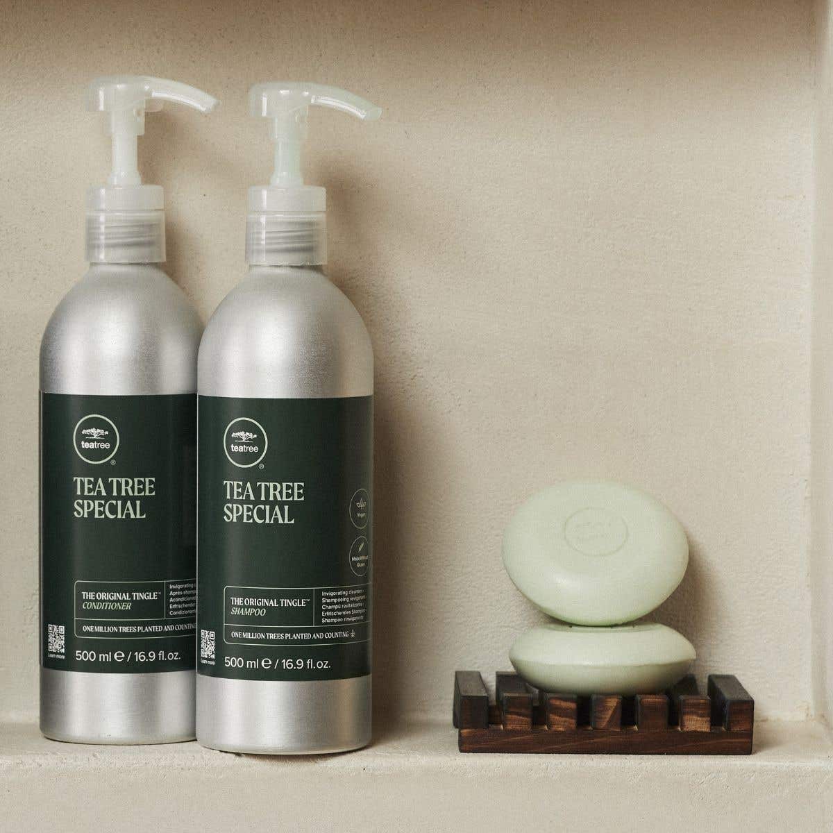 Lifestyle image of Tea Tree Special Aluminum Bottle's and Shampoo Bar on shower shelf