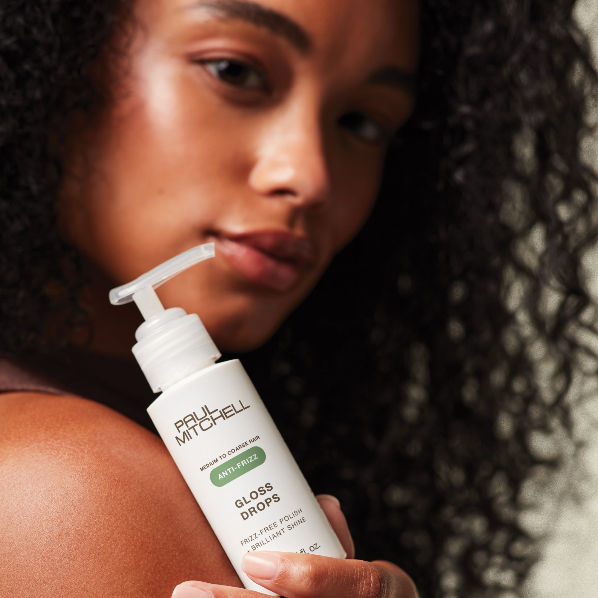 Model holding Gloss Drops