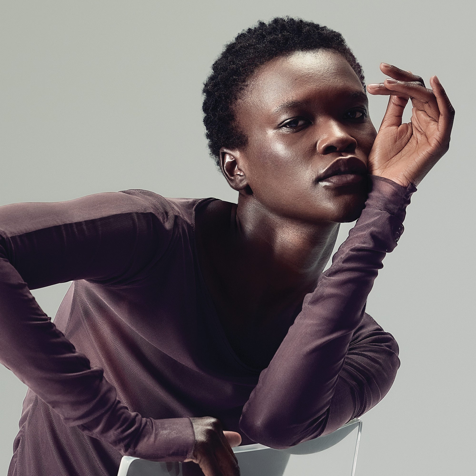 image of a model with short, curly brunette hair