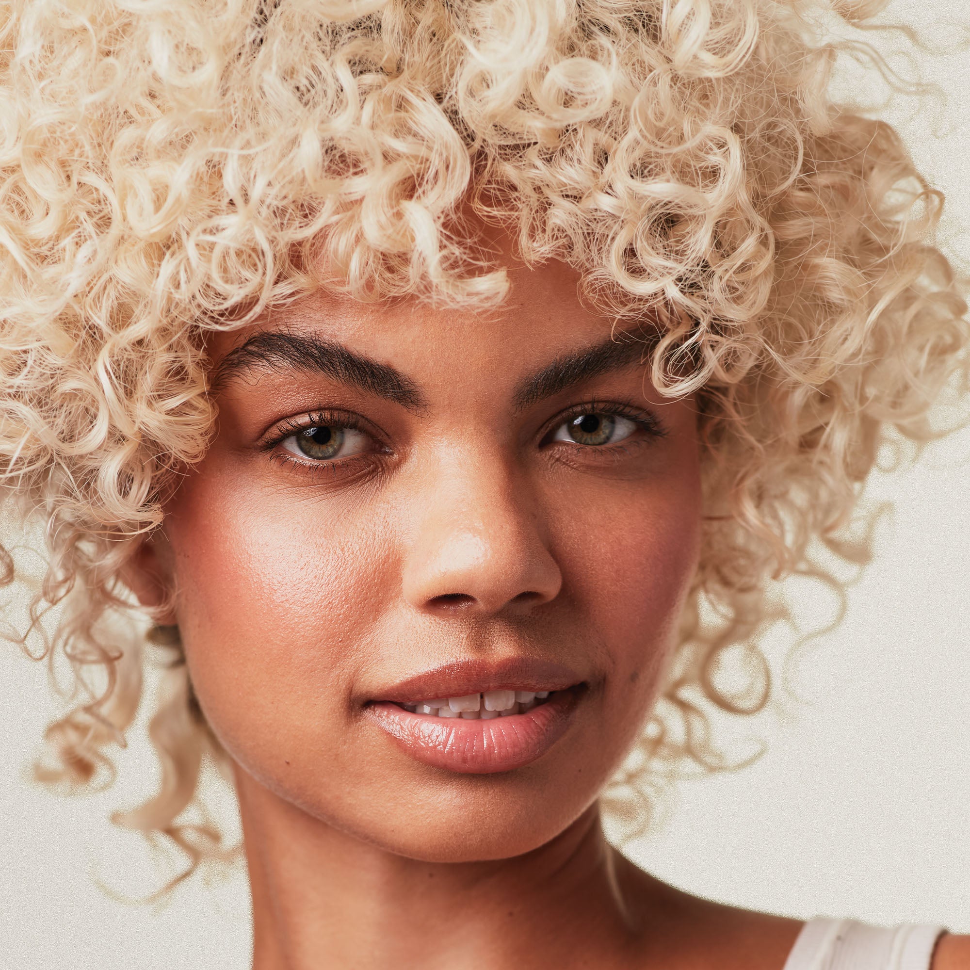 Paul Mitchell Blonde Collection female model with finished look on a neutral background