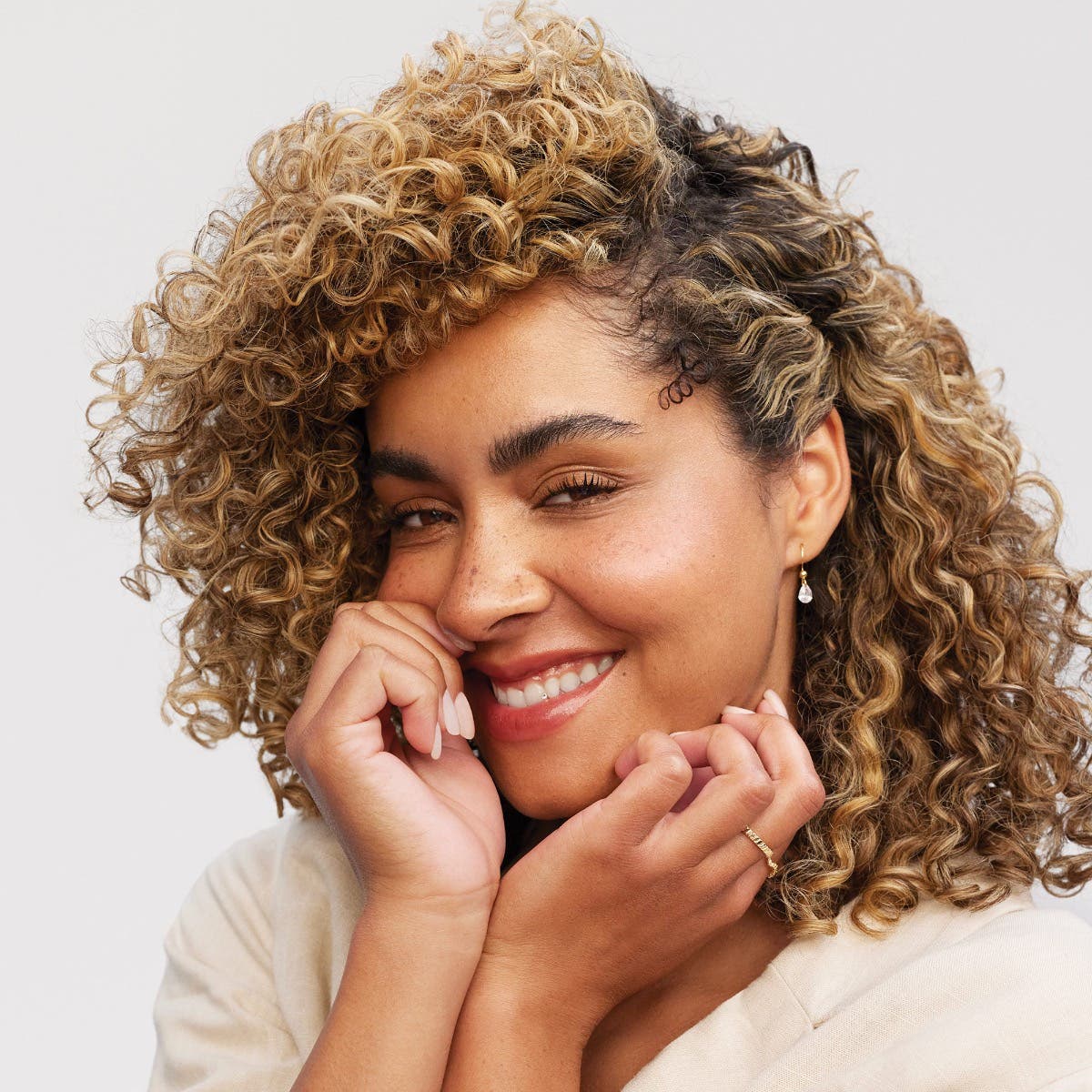 Clean Beauty model with finished curly hair look