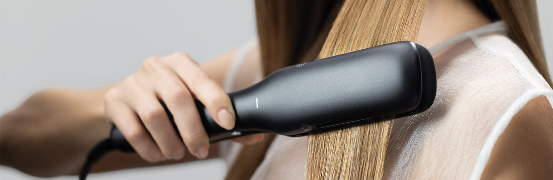 macro image of a woman straightening her hair with a Neuro Smooth+ 1.75-inch flat iron