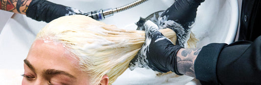 image of a woman with blonde hair receiving a hair rinse