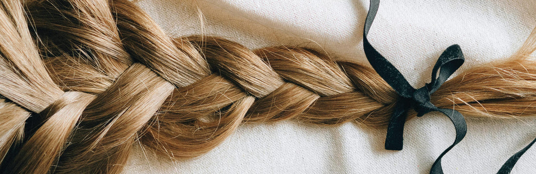 close up image of long, blonde braided hair