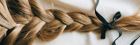 close up image of long, blonde braided hair