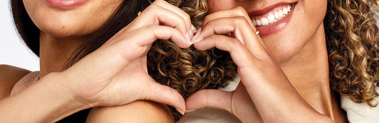 image of two women joining their hands to create a heart