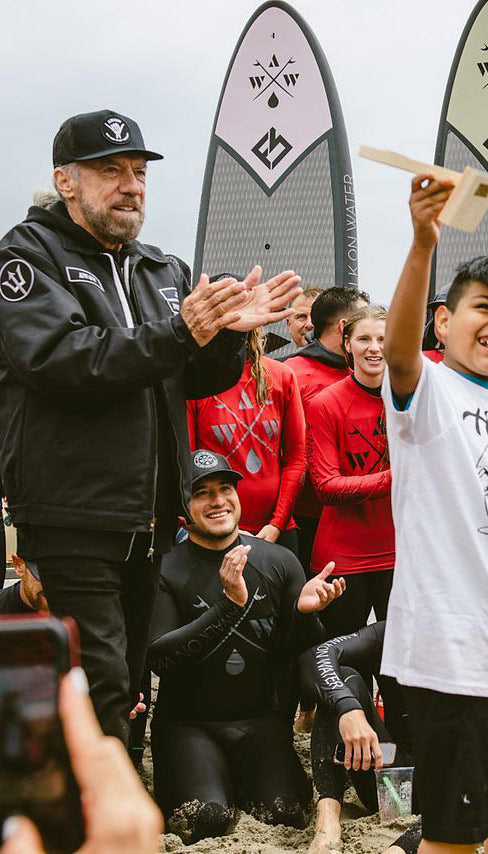 image of kids cheering with John Paul DeJoria at A Walk on Water event