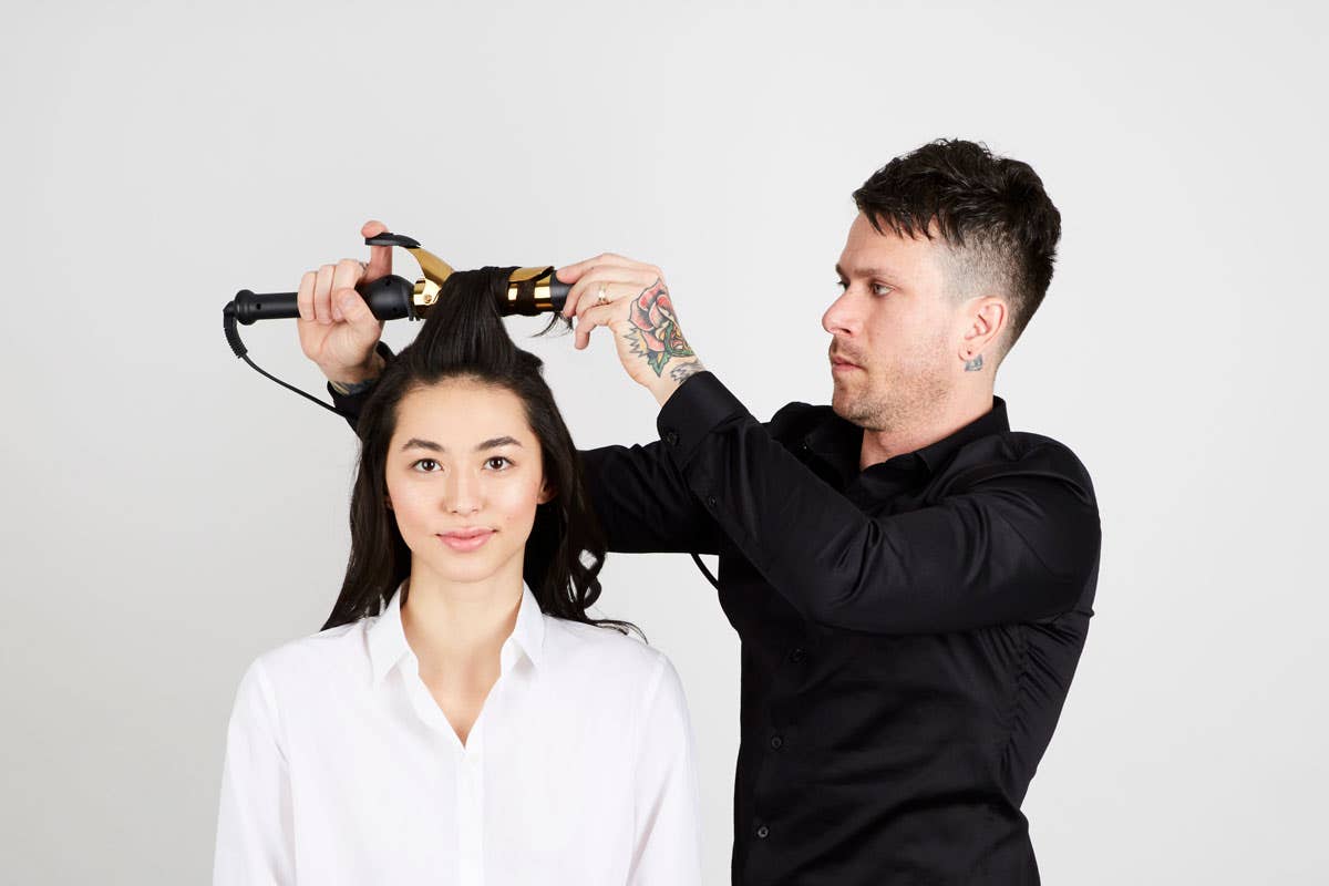 How To: Bouncy Half-Up Pony Step 7 of 14. Use Express Ion Gold Curling Iron to curl hair away from face.