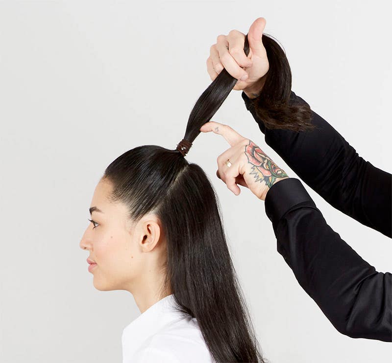 How To: Bouncy Half-Up Pony Step 12 of 14. Use your fingers to wrap rubber band with strands of hair.
