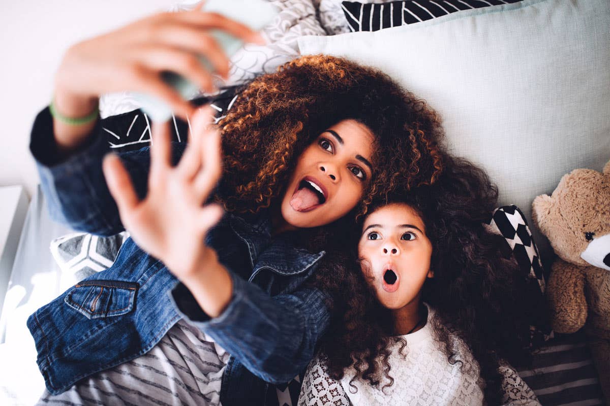 Mom and daughter taking a selfie of themselves.