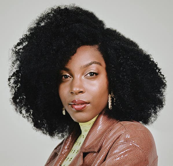 image of model with coily hair styled with Paul Mitchell Flexible Style Sculpting Foam