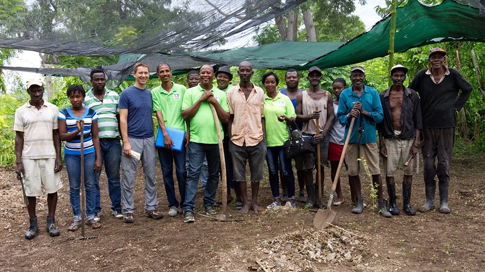 image of reforest'action workers alongside local farmers